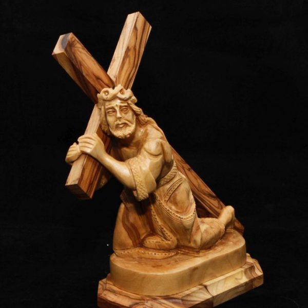 Jesus holding the cross kneeling 1